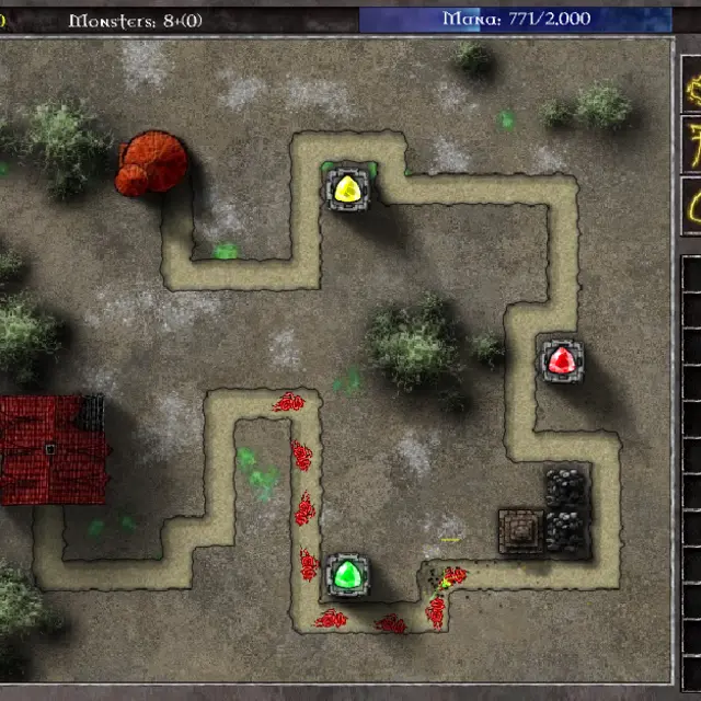 GemCraft Chapter 0 battle with yellow, red and green gems in towers along a sandy road and defeated monsters on the path